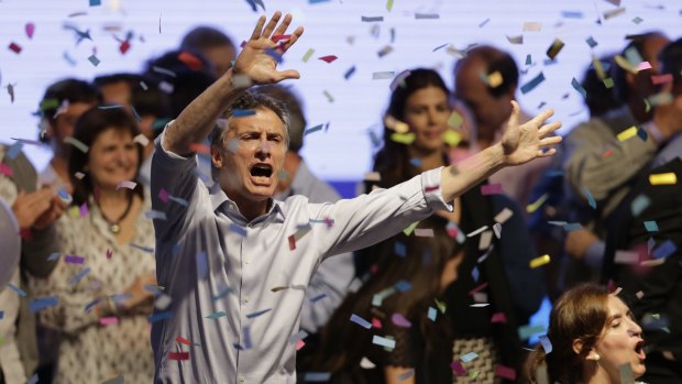 Presidential candidate Mauricio Macri dances  after speaking to supporters in October.