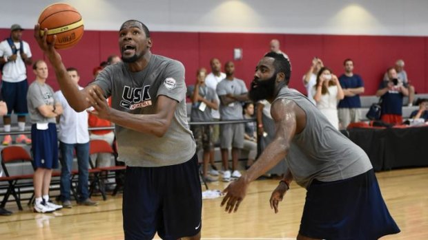 Withdrawn: Kevin Durant, who has opted out of playing for Team USA at the World Cup, drives past national teammate James Harden in practice.