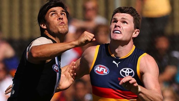 Port's Angus Monfries and Adelaide's Patrick Dangerfield have eyes only for the ball.