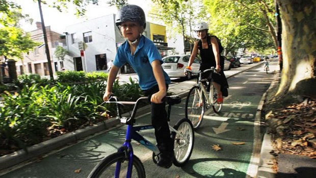 Passing on a tradition &#8230; Lydia Ho rides with her son Arki, 6, to Bourke Street Public School.