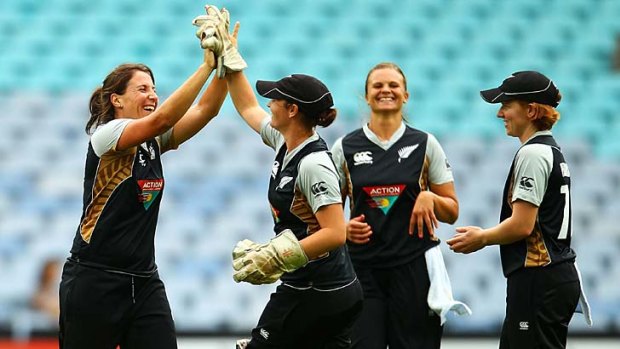New Zealand's Kate Broadmore high-fives with wicketkeeper Katey Martin after having Australia's Sarah Coyte stumped.