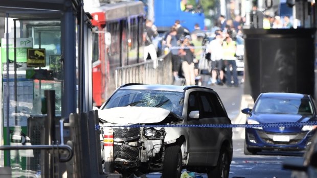 The damaged vehicle after it ploughed through a crowded intersection and then smashed into a tram stop. 
