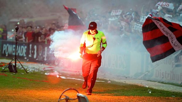Out of control ... a flare which was thrown onto the pitch during the Sydney derby.