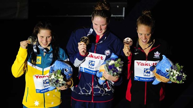 Gold medallist Missy Franklin (centre), silver medallist Belinda Hocking (left) and bronze medallist Hilary Caldwell pose on the podium.