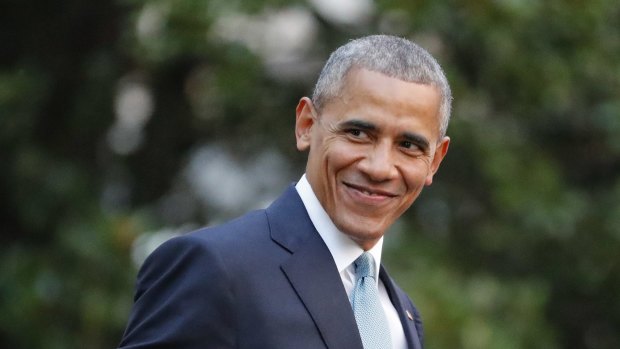 President Barack Obama smiles as he walks across the South Lawn of the White House.