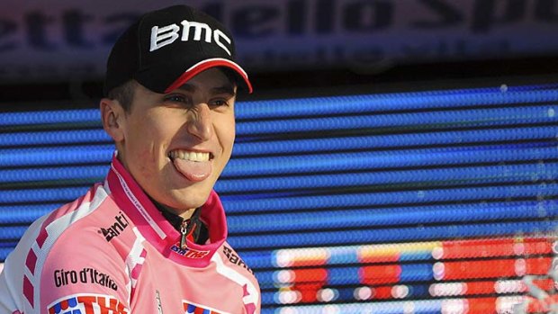 Taylor Phinney, teammate of Cadel Evans, celebrates as he wears the overall leader's pink jersey.