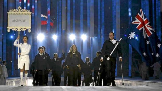 Flag-bearer Cameron Rahles-Rahbula leads Australia's contingent during the opening ceremony of the 2014 Paralympic on Friday.