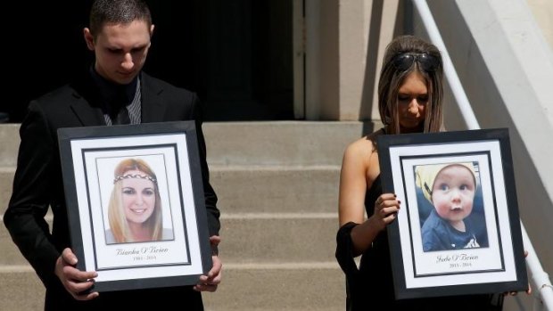 Killed in the blast: relatives of Bianka and Jude O'Brien carry their photographs at their funeral.