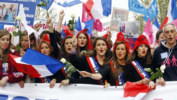 Anti-gay marriage demonstrators waving flags and chanting slogans protest in Paris.