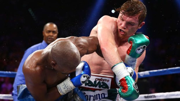 Canelo Alvarez throws a right at Floyd Mayweather Jr. during their title fight.