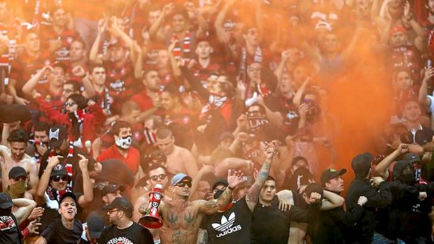 Wanderers fans let off flares during the A-League match between Melbourne Victory and the Western Sydney Wanderers at AAMI Park in Melbourne.