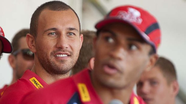 Listen and learn &#8230; Quade Cooper looks on as Reds mate Will Genia takes the mic.