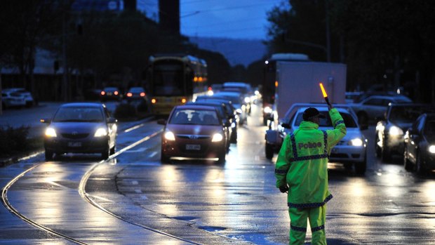 Police direct traffic around the CBD in Adelaide during the blackout.