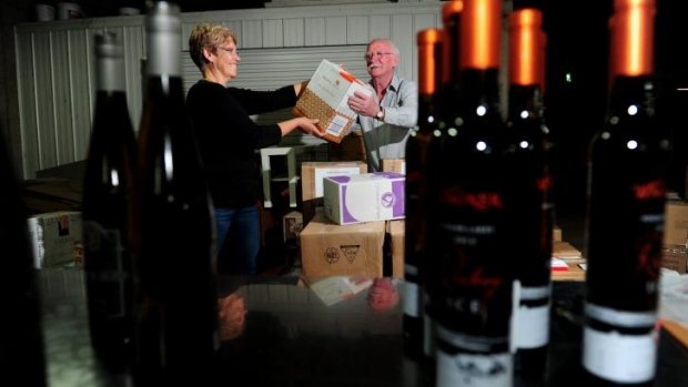 Thirsty work: From left, Sue Hart, executive officer of the Canberra International Riesling Challenge and Ken Helm, chairman of the Canberra International Riesling Challenge, unpack Australian, German, New Zealand, and French rieslings in the basement of the Hyatt Hotel in Canberra in preparation for the Riesling Challenge.