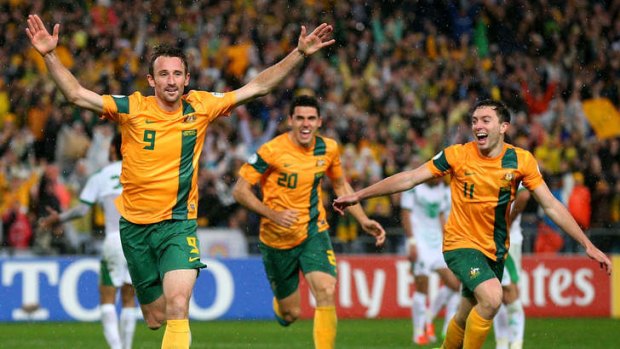 Flying: Josh Kennedy celebrates after heading in the winning goal for the Socceroos.