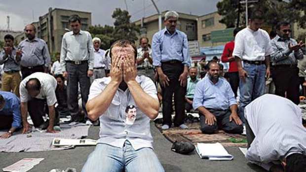 Word on the street ... men pray after listening to Supreme Leader Ayatollah Khamenei's sermon at Tehran University.