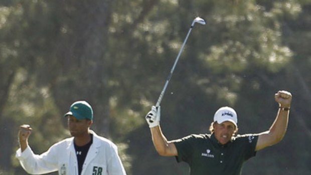 Phil Mickelson (right) celebrates his eagle at the 14th hole with caddie Jim Mackay. Mickelson became just the third player to record successive eagles at the US Masters.