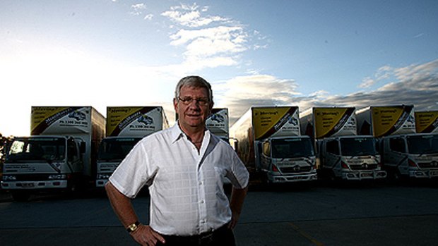 Mike O'Hagan with some of his truck fleet at his MiniMovers depot in Rocklea Brisbane.