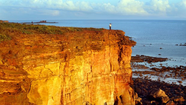 Bowles watches from the cliff top.