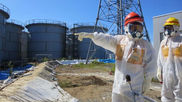 Lethal: Japanese Economy, Trade and Industry Minister Toshimitsu Motegi (left) inspects contamination water tanks at TEPCO's Fukushima Dai-ichi nuclear power plant.