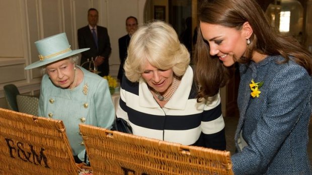 The Queen, the Duchess of Cornwall (centre) and the Duchess of Cambridge like what they see in their Fortnum &amp; Mason hampers.