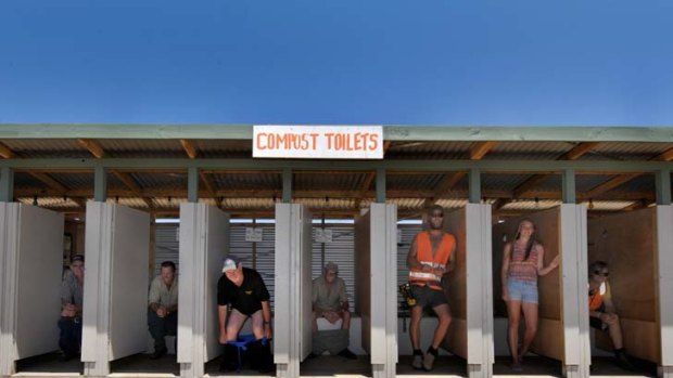 Organisers and locals of the Rainbow Serpent Festival test out the compost toilets.