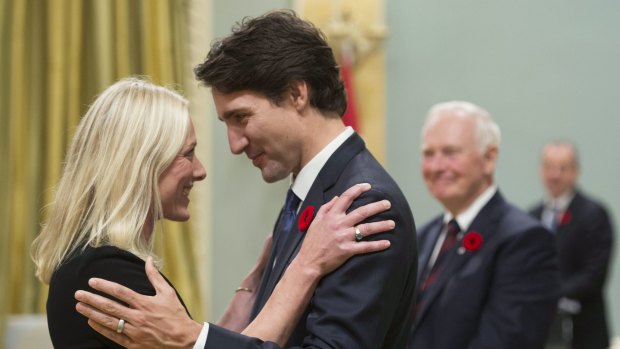 Canadian Prime Minister Justin Trudeau hugs Environment and Climate Change Minister Catherine McKenna.