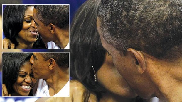 Lip service: the Obamas pucker up after initially giving "kiss cam" a miss. Photo: AP