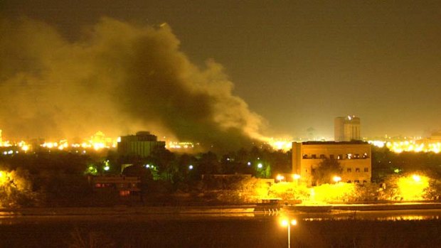 Smoke rises over Baghdad: One of Saddam Hussein's palaces on the Tigris River burns after a missile strike during the invasion.