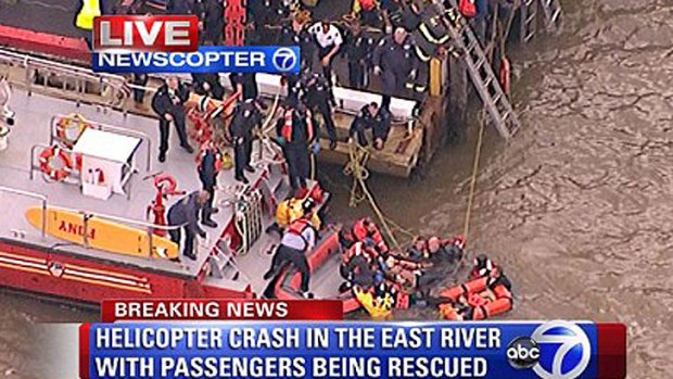 Rescuers work at the scene of the helicopter crash in New York's East River.