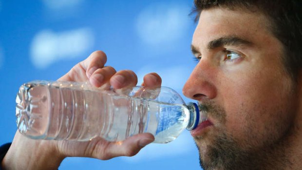 US swimmer Michael Phelps takes a sip of water during a press conference at the Gold Coast Aquatic Centre.