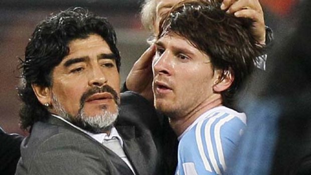 Failed to shine ... Lionel Messi, right, is comforted by Argentina coach Diego Maradona at the end of the game.