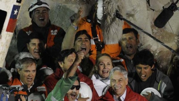 The last of the 33 Chilean miners to be rescued, Luis Urzua (C), celebrates his recue.