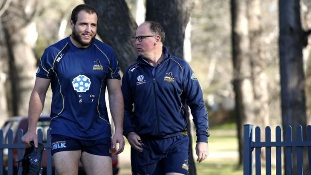 ACT Brumbies player Ben Alexander chats with coach Jake White.