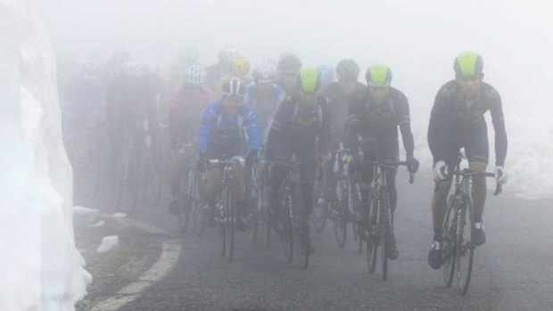 Gruelling: Riders climbed through sheets of snow and rain on stage 16 of the Giro d'Italia.