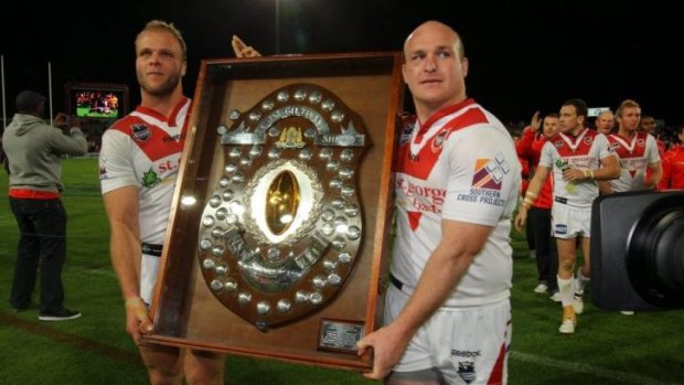 Jarrod Saffy and St George Illawarra teammate Michael Weyman hold the JJ Giltinan Shield during their NRL premiership-winning season in 2010.