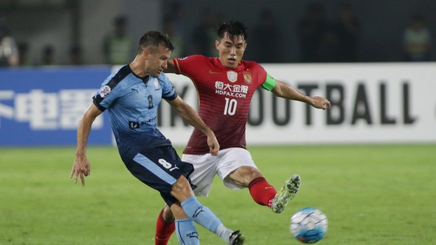 Significant match: Milos Dimitrijevic competes with Guangzhou Evergrande opponent Zheng Zhi during the AFC match at Tianhe Stadium on May 3.