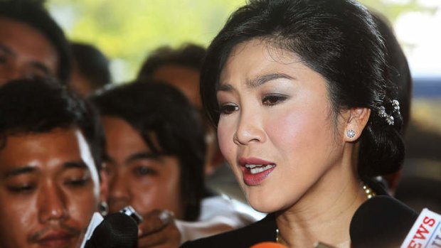 Yingluck Shinawatra, Thailand's prime minister, speaks to members of the media as she arrives at Parliament House in Bangkok.