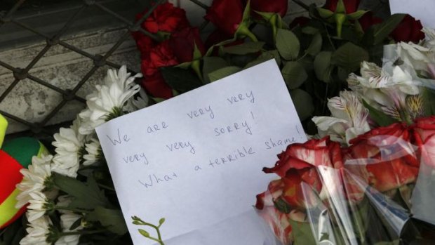 Flowers and message of condolence are left outside the Dutch embassy in Moscow.
