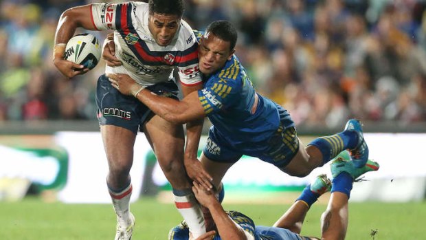 Going nowhere: Michael Jennings of the Roosters is tackled by Will Hopoate of the Eels.