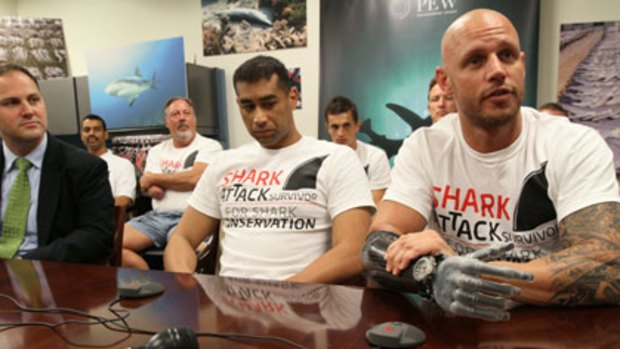 Paul de Gelder, right, speaks at a news conference in New York. He lost his hand in the attack.