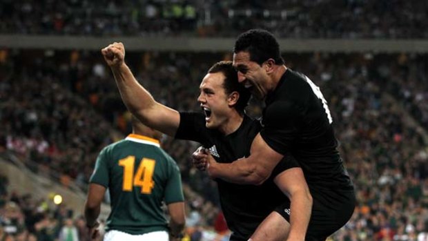Israel Dagg of the All Blacks celebrates with team mate Mils Muliaina after scoring the match winning try in Soweto.