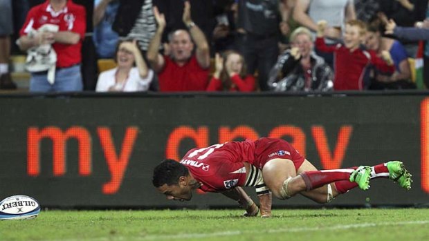 Digby Ioane of the Reds celebrates after scoring with his 'scorpion' move.