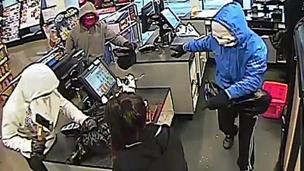 A CCTV still image shows the gang in action in a Port Melbourne supermarket.