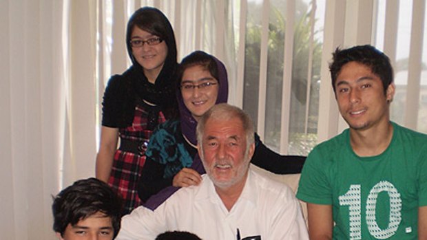 The Karimi family in their Dutton Park home. (from top left) Farida, 19, Sediqa, 21, their father Ali, Elias, 18, Murtaza, 13, and Edris, 16.
