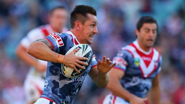 Trifecta: Rooster Mitchell Pearce takes off with the ball against the Dragons.