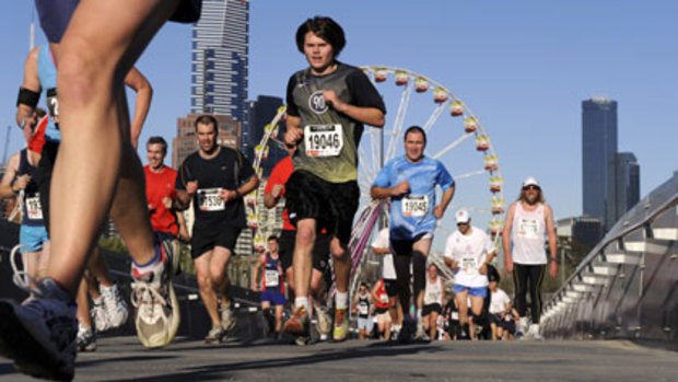 Competitors struggle across the William Barak Bridge during yesterday's Melbourne Marathon, the city's biggest footrace.