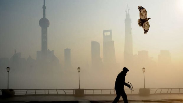 A man flies a kite at The Bund in Shanghai, China amid heavy smog.