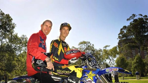 Jim Stynes with Cam Sinclair, a moto-cross stunt man who will perform before Saturday's MCG game.
