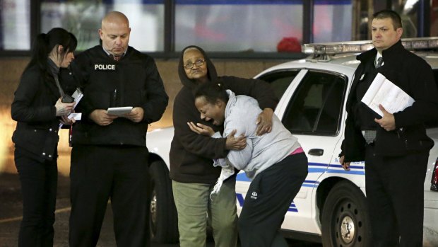 Toni Martin, the mother of Antonio Martin, cries out as she is interviewed by police at the scene of her son's shooting.